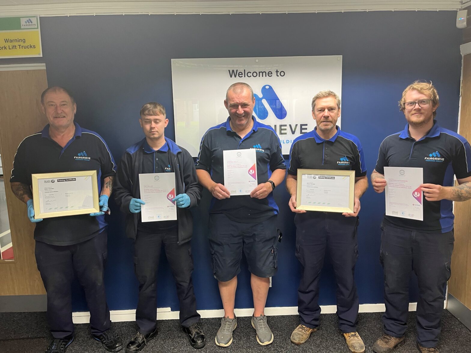 Fairgrieve staff members receiving defibrillator training certificates.